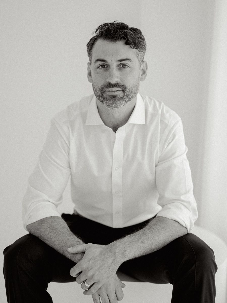 Dr. Benjamin Subtelny, oral and maxillofacial surgeon, seated in a white shirt